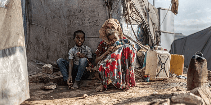 A group of women with their children, between the tents in Al Malika displaced persons camp
