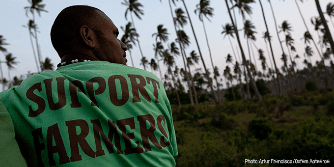 Man outside with t-shirt that says "support farmers"