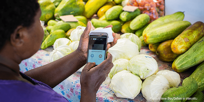 woman taking photos of vegetable