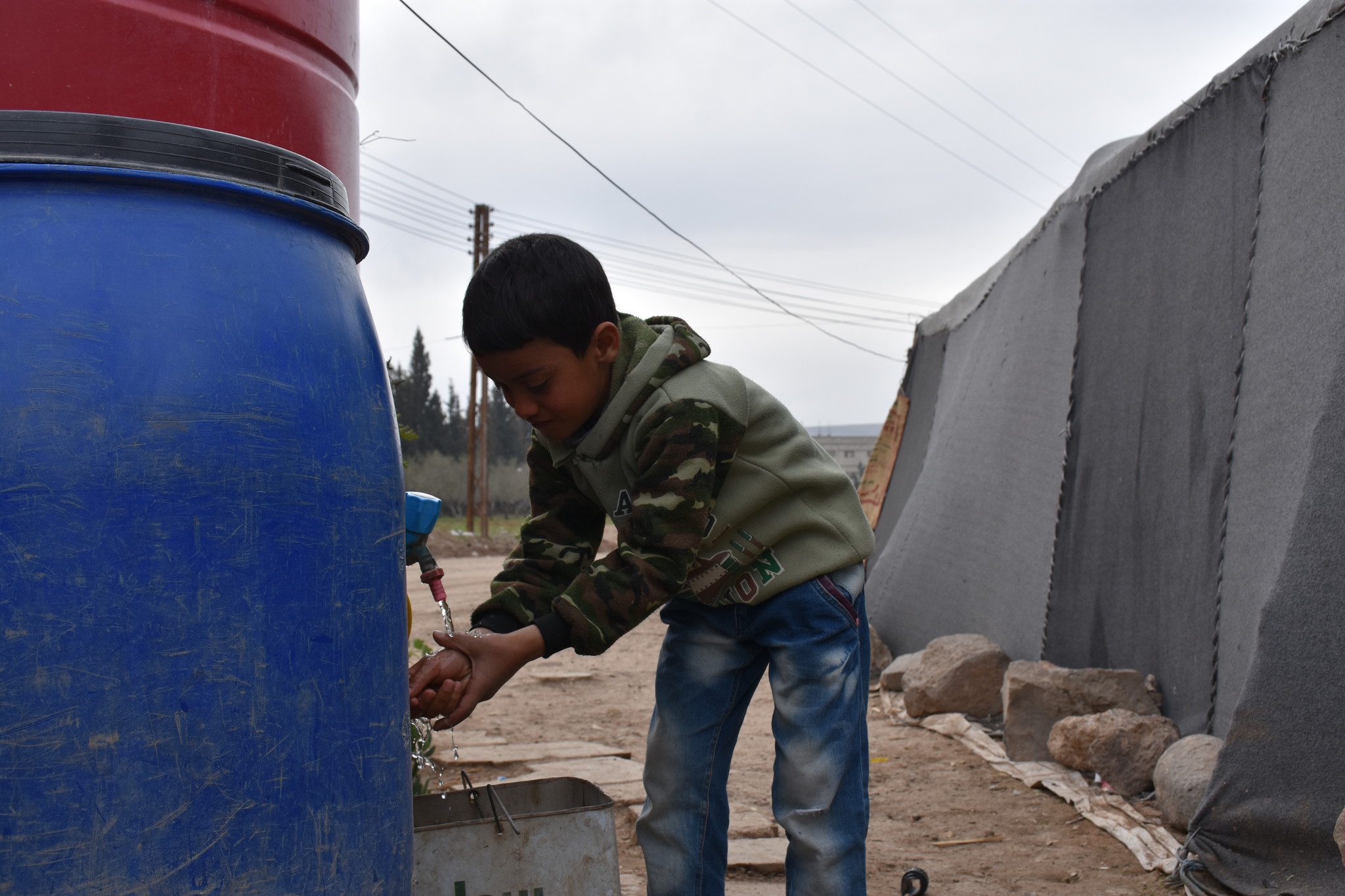 A young boy collects water