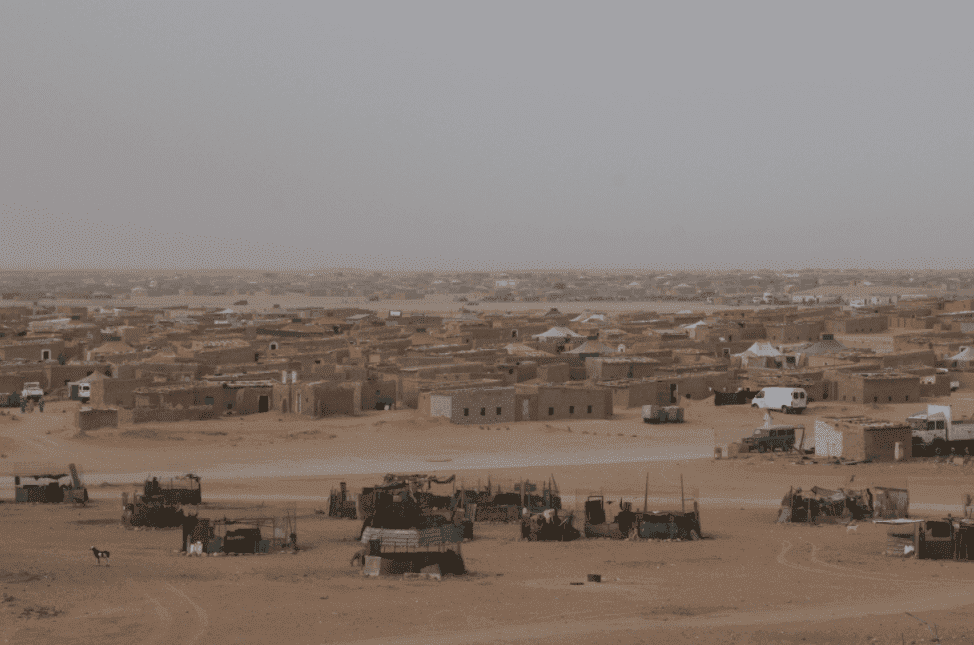 Sahrawi refugee camp, with beige sand and a muted blue sky