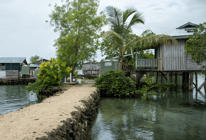 Image of a pathway to a home over water