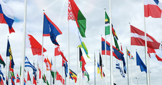 Image of different flags against a blue sky