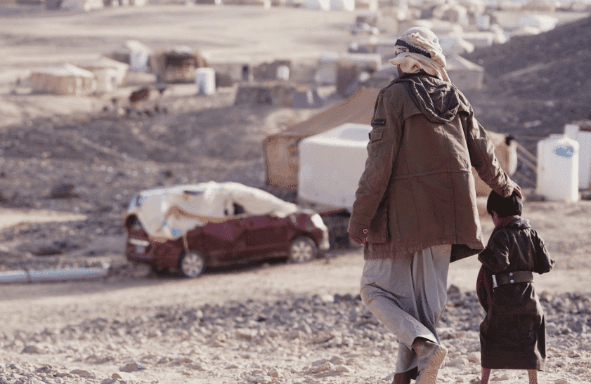 Image of a father and his child walking side by side