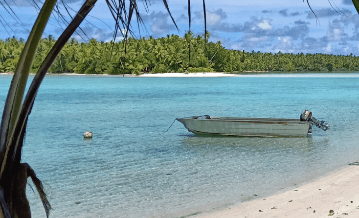 A boat sits in clear blue water