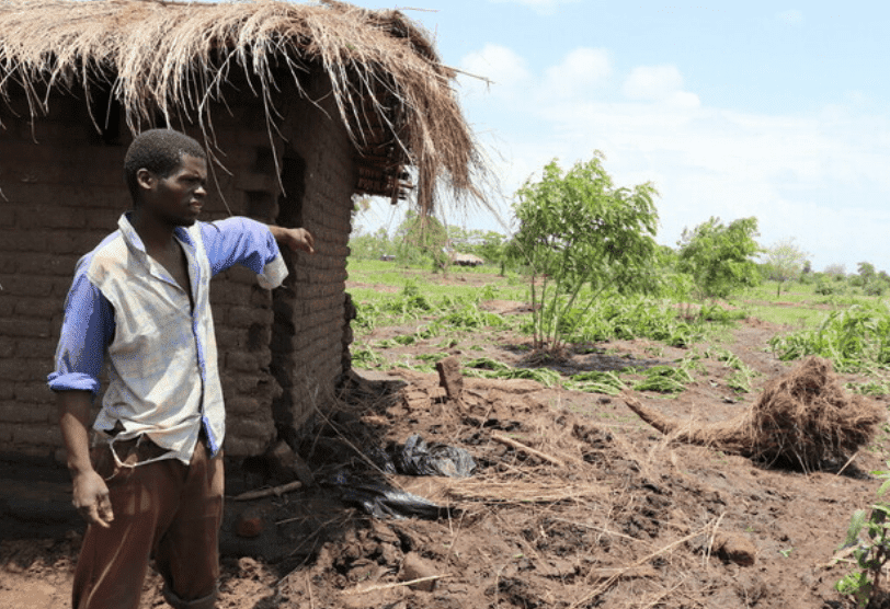 A man stands by the damage of the recent cyclone in Southern Africa