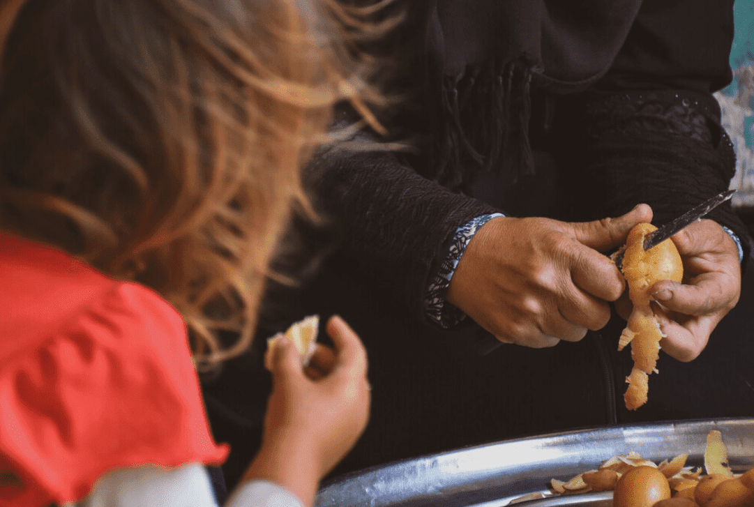 Close up of a mother cutting vegetables