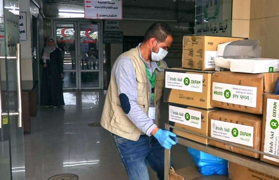 A man carries boxes of Covid supplies