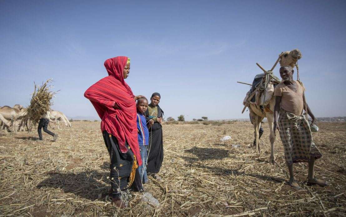 A group of people standing in a dry area