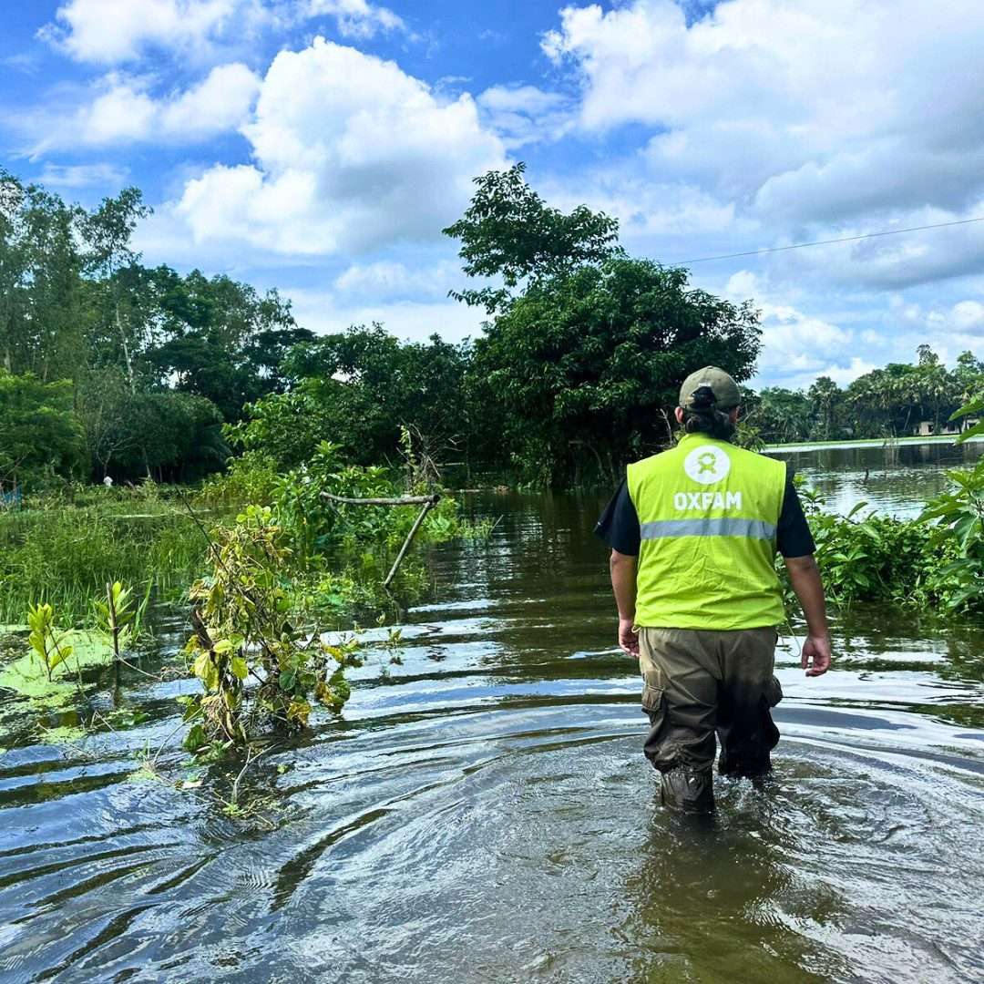 Oxfam staff walking in Bangladesh flood