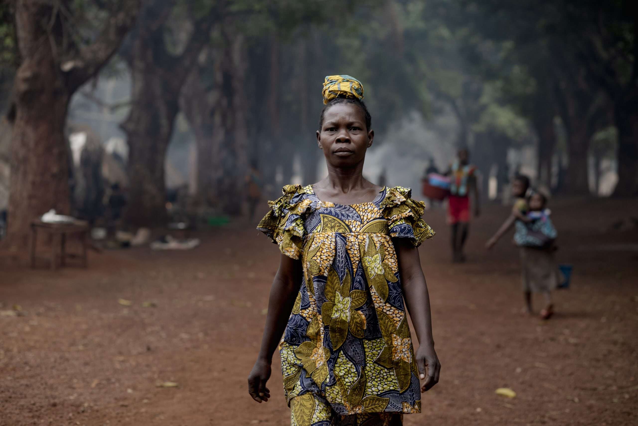 Marcelline walks to get water buckets
