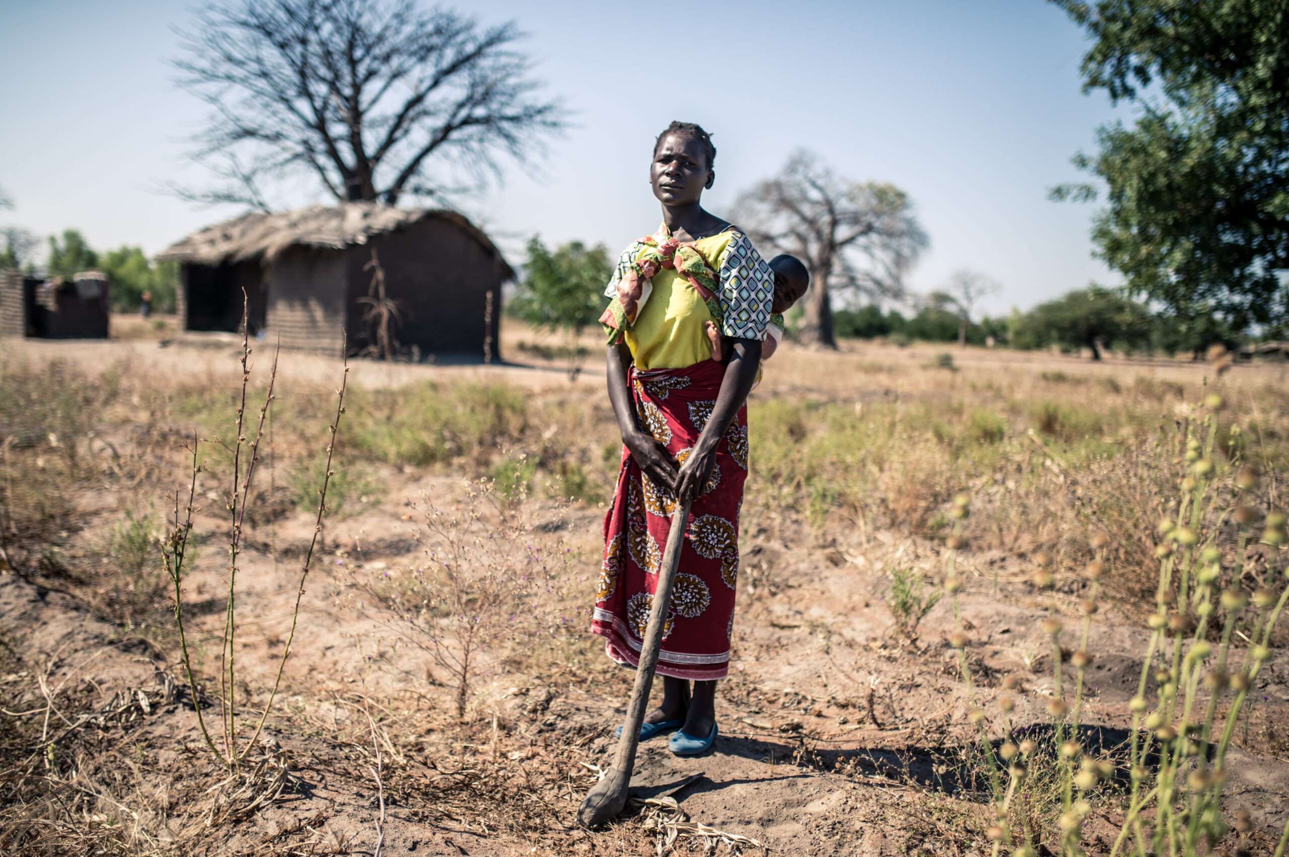 Blantyre Rural, Malawi: Elube (32) stands with her baby, in Malawi