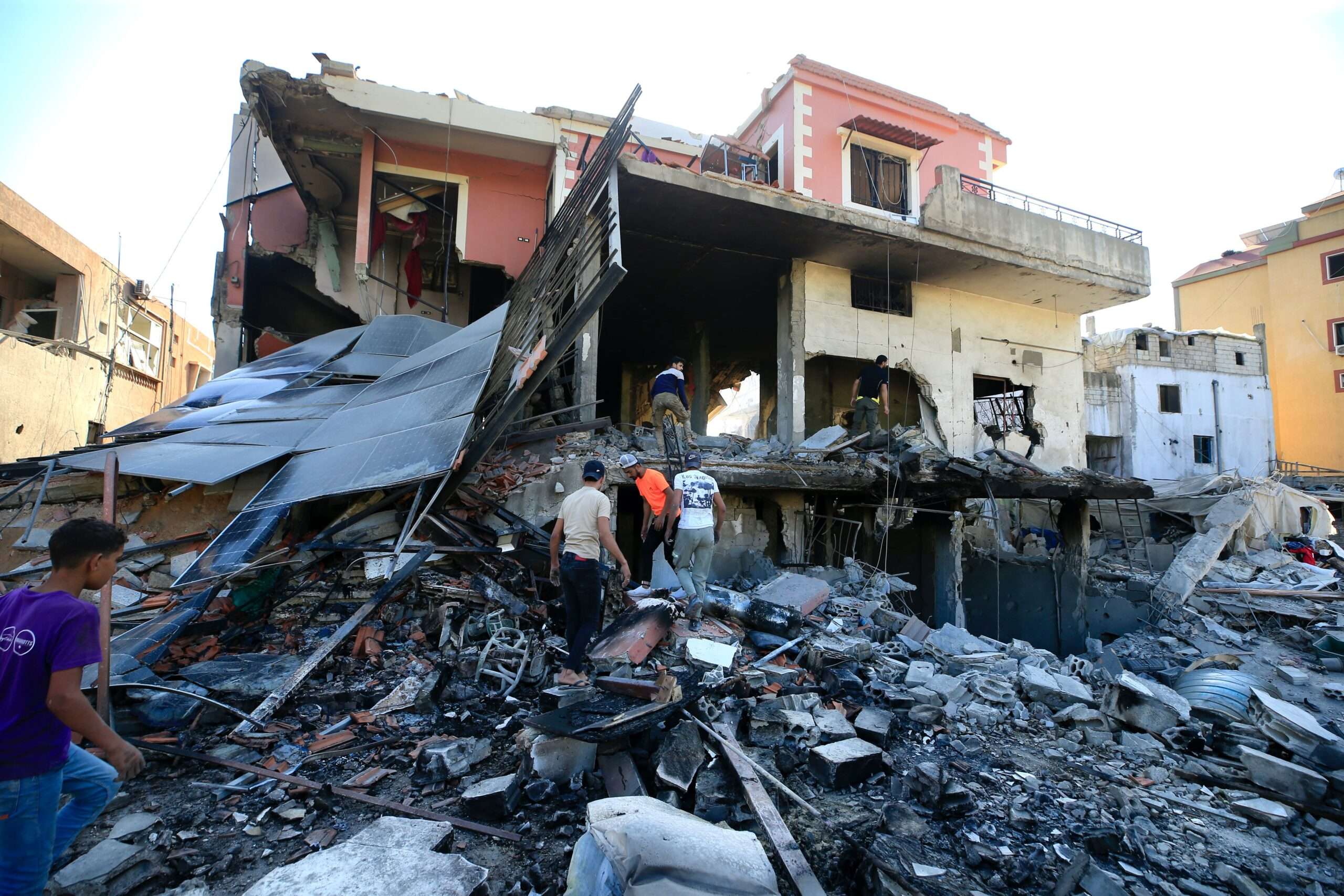 Lebanese people search for their belongings in a damaged building