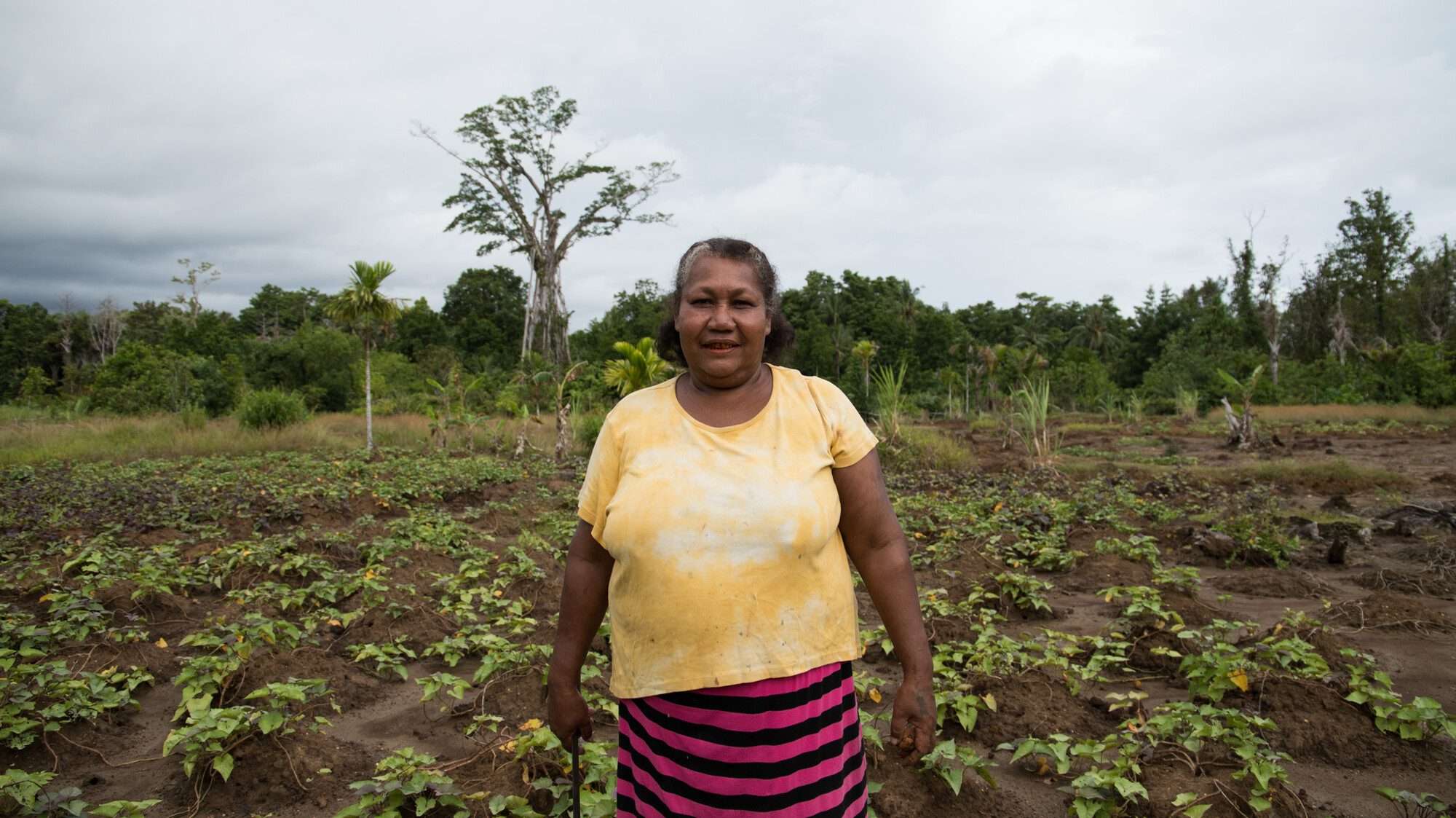 Adriana in the Solomon Islands in front of her vegetable garden.
