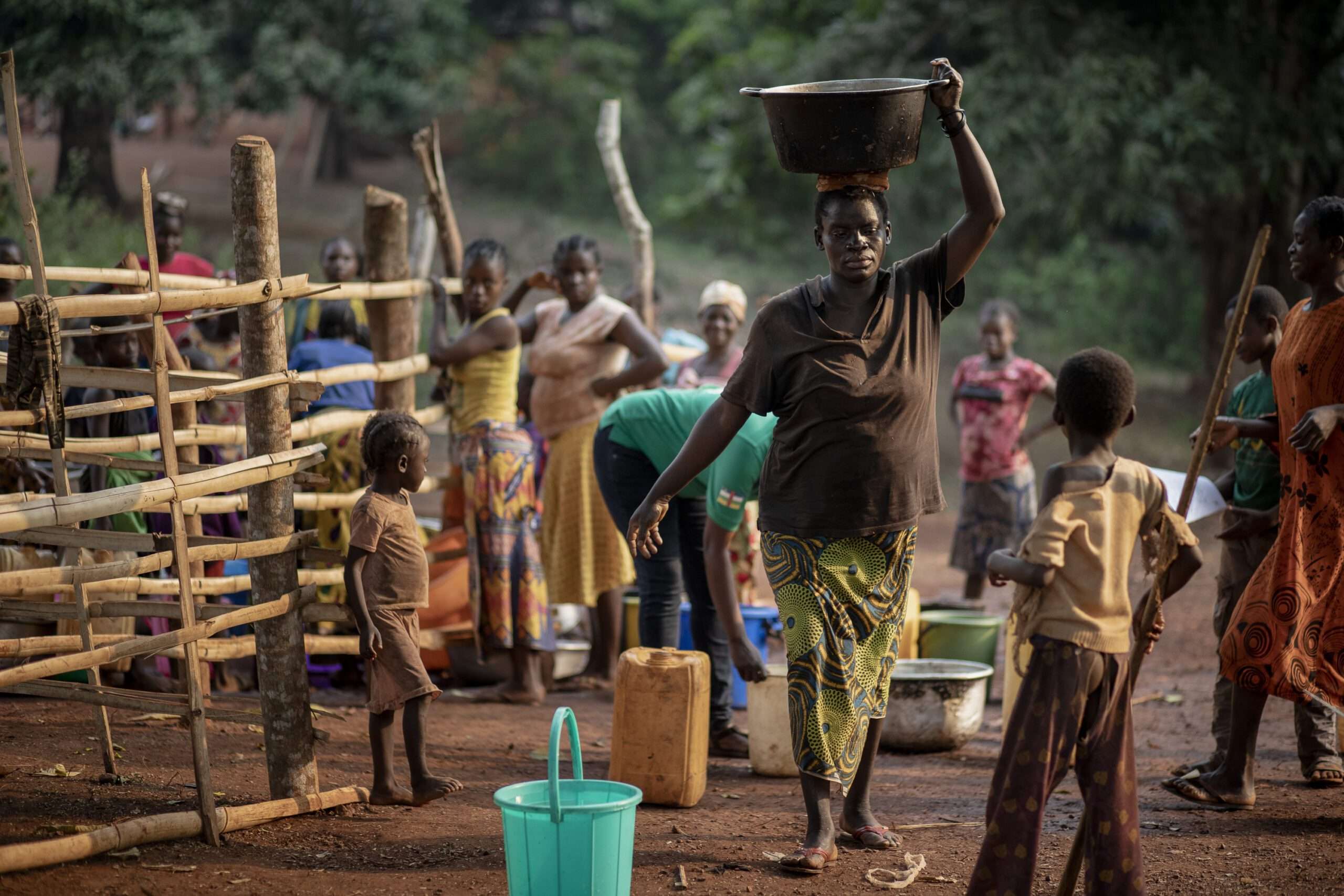 Woman carrying bucket of water on head