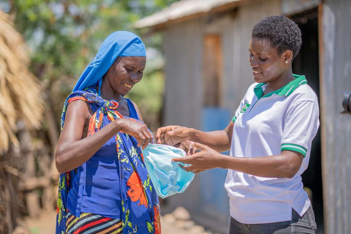 Two women going through sanitary kit