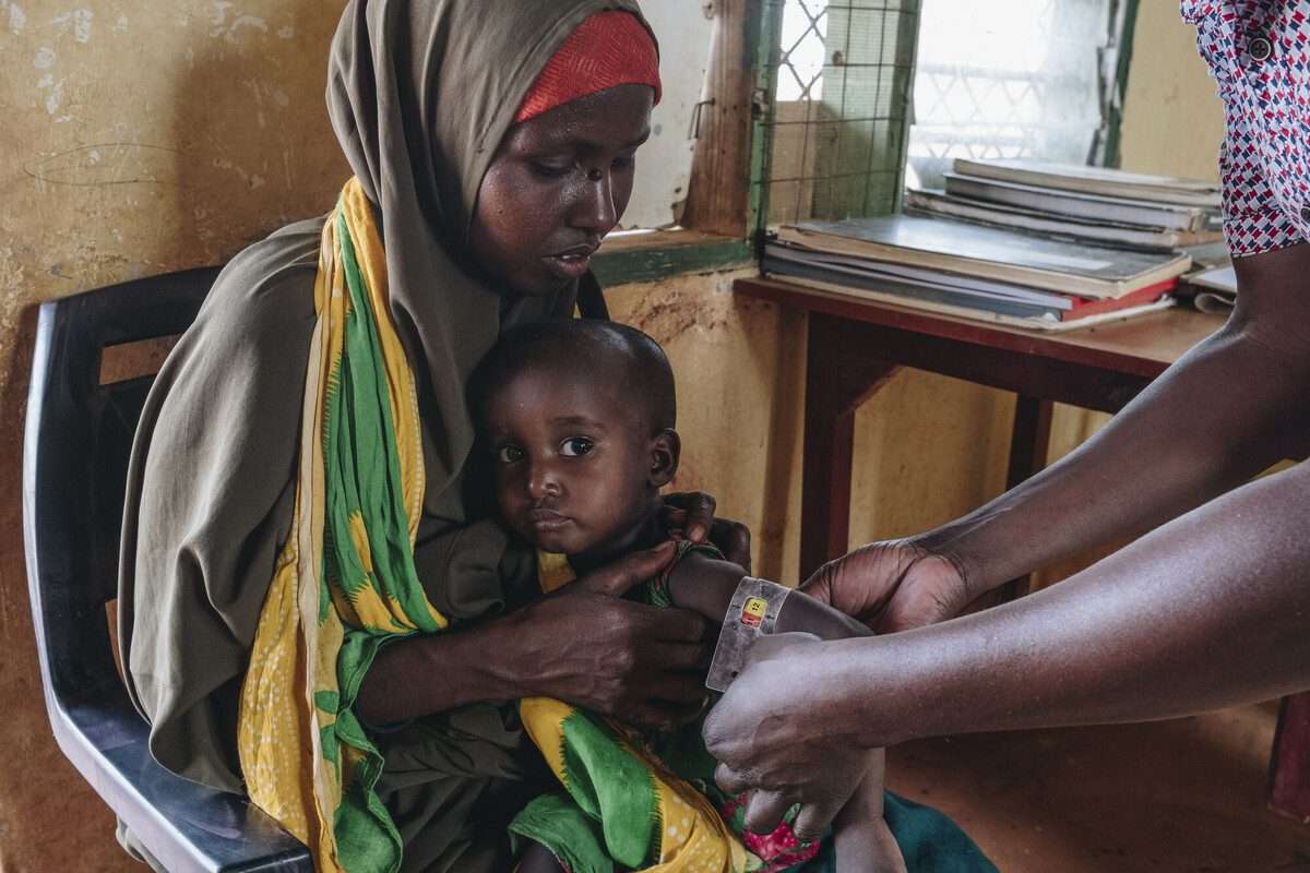a woman in Eithiopia brings her young daughter for a medical exam