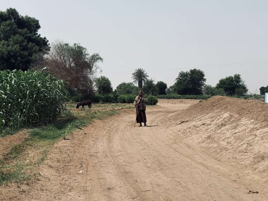 Man standing alone on barren road.