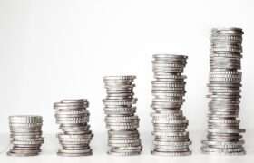 coins stacked on top of eachother, piles increasing in height