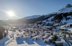 drone shot of city of DAVOS in snow
