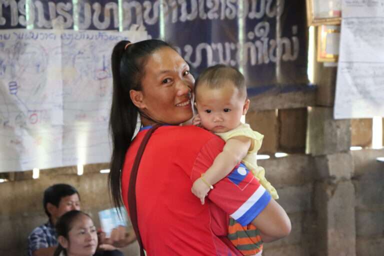 Woman holding baby in Laos