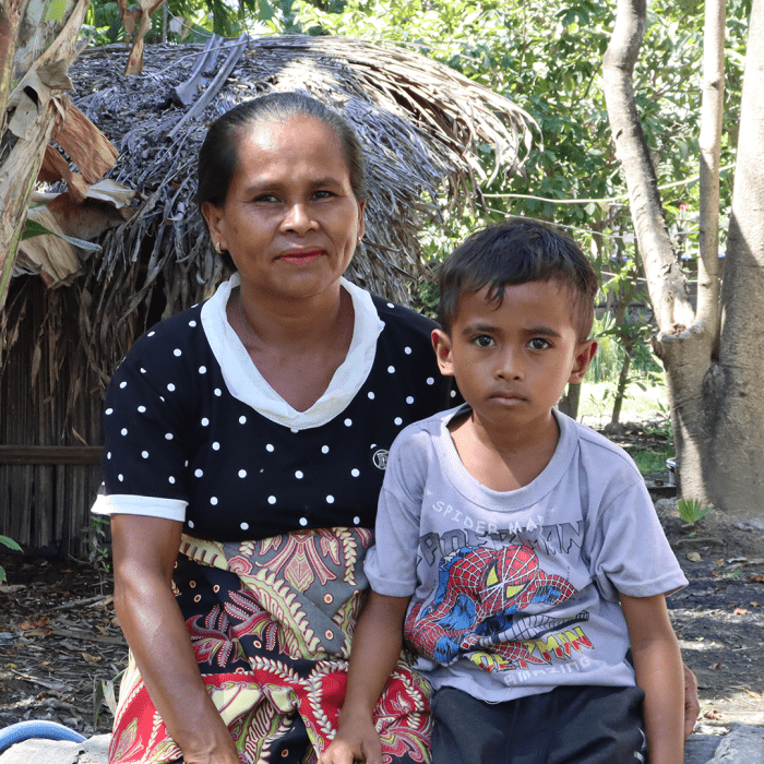 lady (monica) and her son by their home - give a gift