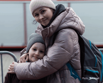 A mother hugs her young son