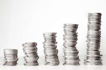 coins stacked on top of eachother, piles increasing in height