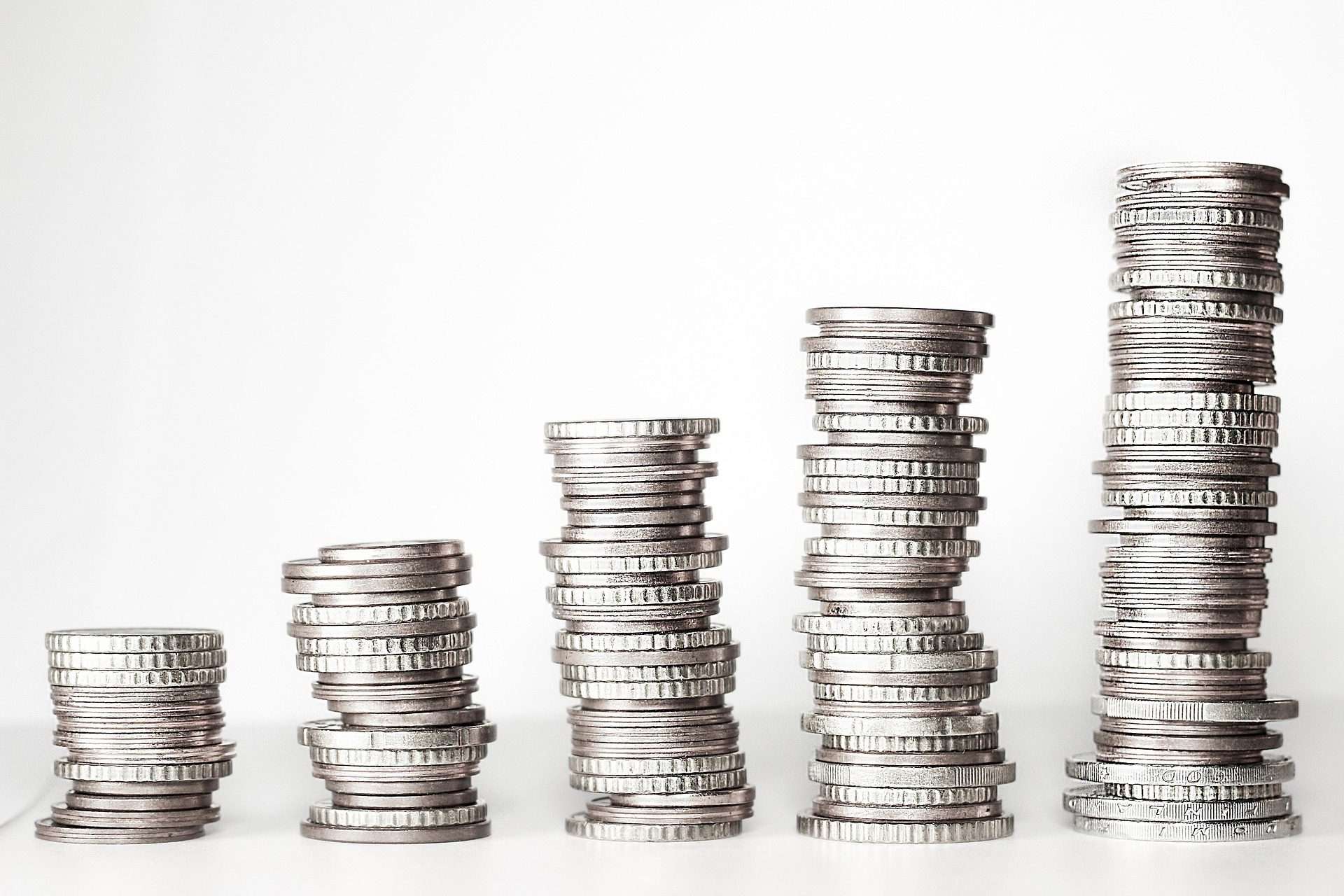 coins stacked on top of eachother, piles increasing in height