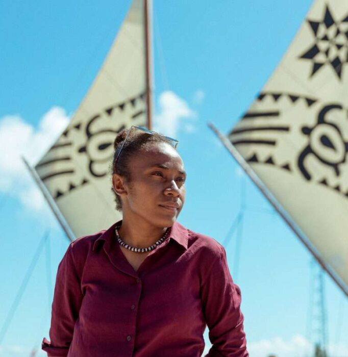 Cynthia Houniuhi, president of Pacific Island Students Fighting Climate Change (PISFCC) in front of the Uto ni Yalo boat docked at Nuku'alofa. Campaign Make Rich Polluters Pay for the damage they cause