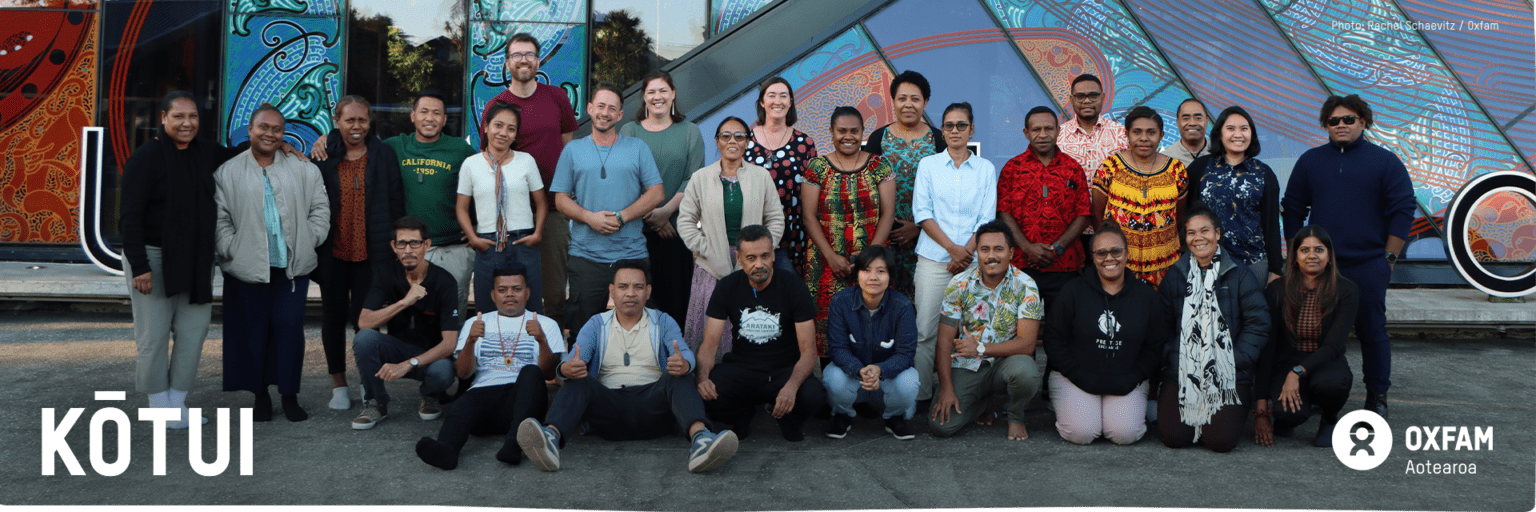 Banner with Kōtui staff gathered in Auckland at Te Kete event